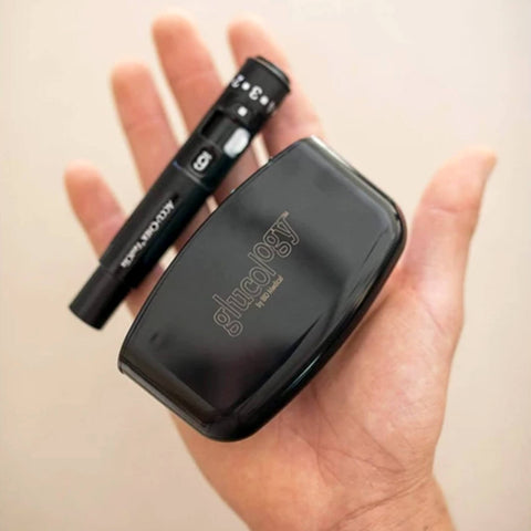 Hand Holding The Glucology Pen Needle Pocket Container (lancing device not included). Hand Holding The Glucology Pen Needle Pocket Container (lancing device not included).