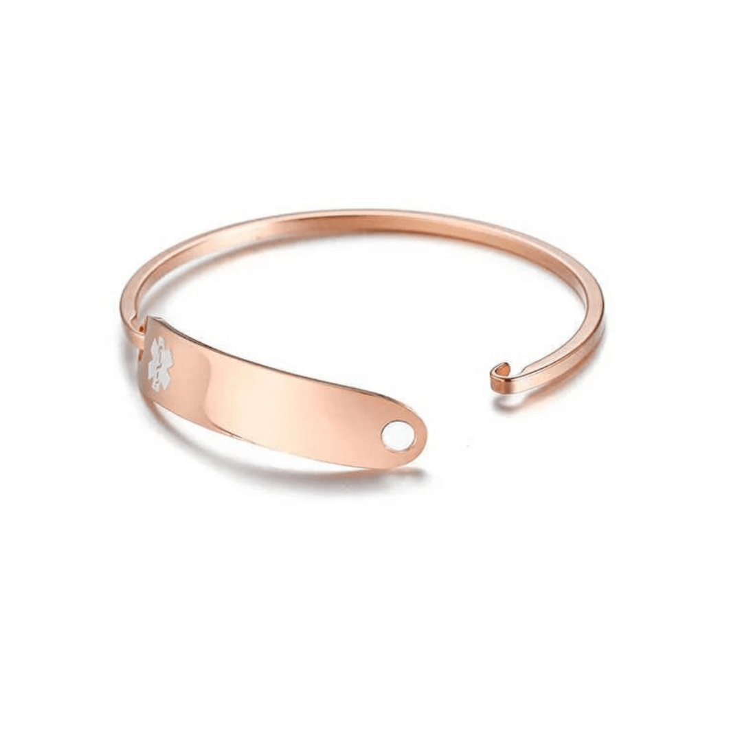 Rose gold coloured stainless steel medical alert bangle shown opened. It has red medi-alert symbol and comes engraved with 'Type 1 Diabetes', 'Type 2 Diabetes' or 'Insulin Dependent'.