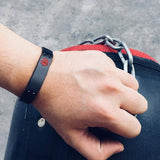Matt black coloured stainless steel medical alert: linked bracelet modelled on wrist. It has red medi-alert symbol and comes engraved with 'Type 1 Diabetes', 'Type 2 Diabetes' or 'Insulin Dependent'.