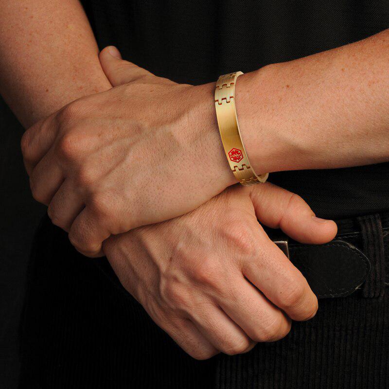 Brushed gold coloured stainless steel medical alert: linked bracelet modelled on wrist. It has red medi-alert symbol and comes engraved with 'Type 1 Diabetes', 'Type 2 Diabetes' or 'Insulin Dependent'.